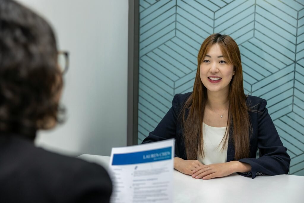 Why Job Boards and Legacy Outsourcing No Longer Scale? 1 Young woman in a business meeting with an interviewer, showcasing confidence and professionalism.
